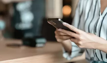 mujer usando un smartphone en una cafeter�a