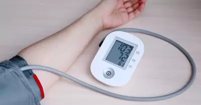 Mujer midiendo la presin arterial con autonmetro digital electrnico.
