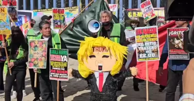 Activistas queman pi�ata con la figura de Trump frente al muro internacional en 